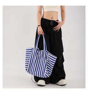 Detail of blue and white striped canvas tote bag showing large capacity and thick fabric