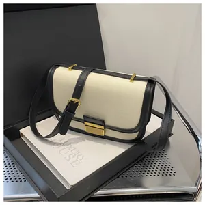 Detail of contrast stitching saddle bag with gold metal buckle on luxury gift box