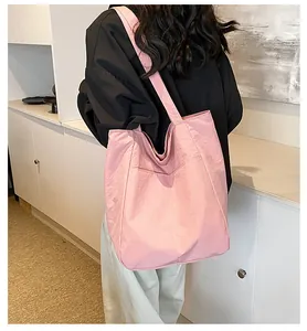 Detail view of pink Oxford tote bag showing side pocket and wide shoulder strap