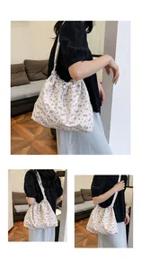 Détail du sac à cordon fleuri montrant la bandoulière décontractée et le motif en tissu