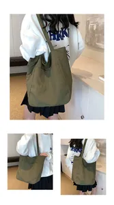 Detail of army green nylon tote bag featuring side pockets and textured surface for daily use