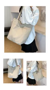 Detail of beige oxford tote bag showing dual front pockets and durable fabric texture