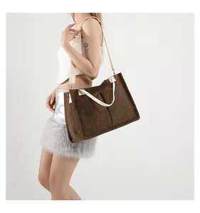 Detail of floral corduroy tote bag showing front pockets and cream webbing handles
