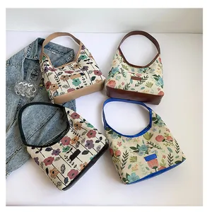 Detail of four floral jacquard hobo bags in different colors with PU leather trim
