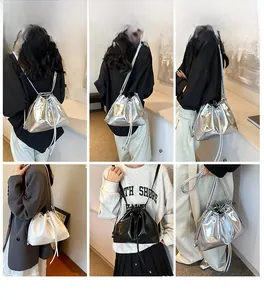 Three-color minimalist drawstring bucket bag shown in silver, black, and white leather