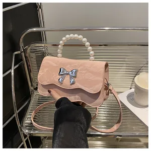 Detailed shot of pink marble texture bag featuring pearl handle and silver bow buckle