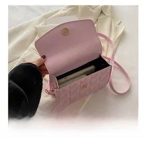 Pink quilted crossbody bag with metal magnetic closure showing internal capacity
