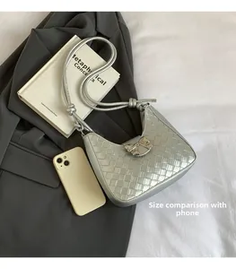 Detail of silver woven hobo bag with bow decoration and size comparison with phone