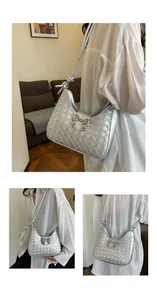 Close-up of silver crescent bag featuring woven texture and decorative metal bow knot