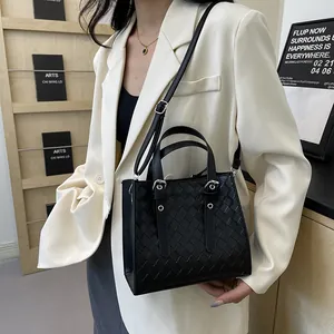 Elegant black woven textured crossbody bag for women with top handle and shoulder strap