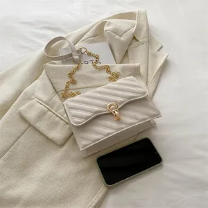 Minimalist white chevron quilted chain crossbody bag with unique gold clasp closure