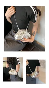 Detailed views of the silver metallic ruched cloud bag with thin shoulder strap