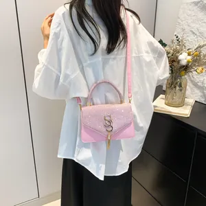 Pink sequin patchwork crossbody bag with gold metal hardware and tassel detail