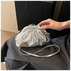 Detailed macro view of silver pleated dumpling bag with metallic texture and fold design