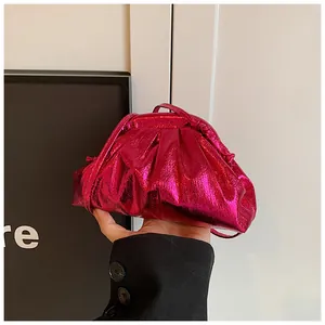 Detail of rose red pleated cloud bag with metallic finish and thin shoulder strap