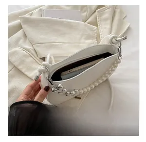 Detail view of white heart handbag showing interior capacity for phone and wallet
