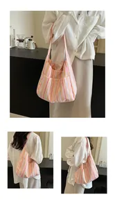 Close-up of pink and orange striped canvas tote bag with an external storage pocket