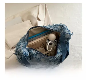 Detailed view of the denim tote bag interior showing its large capacity for daily items