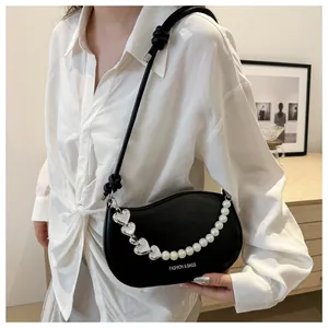 Detail of black crescent crossbody bag with pearl and silver heart beaded chain strap