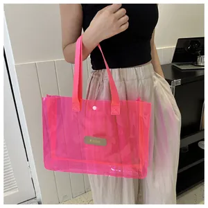 Detail of neon pink translucent tote bag with MS. HUIXIBAG label and snap closure