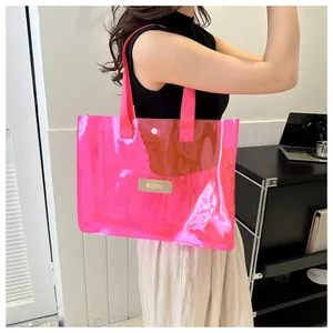 Detailed shot of pink transparent PVC tote bag with canvas handles and logo patch