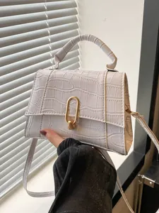 Detailed macro view of cream crocodile texture faux leather with golden oval twist lock
