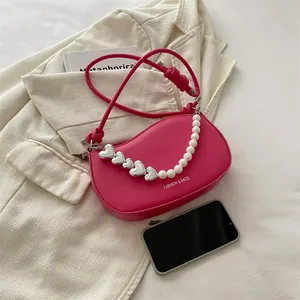 Pink heart-themed PU leather handbag with decorative pearl chain and knotted shoulder strap