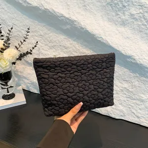 Chic black quilted clutch bag with floral embroidery and metallic zipper closure