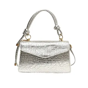 Silver croc-effect small square handbag with knotted handle and gold hardware detail