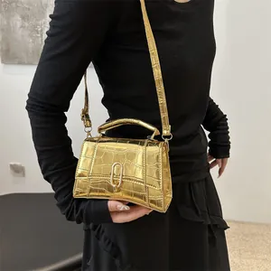 Chic gold crocodile embossed trapezoid handbag with metal U-buckle and shoulder strap