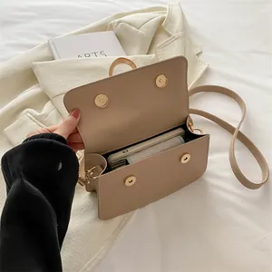 Minimalist khaki PU leather crossbody bag showing internal capacity and magnetic closure