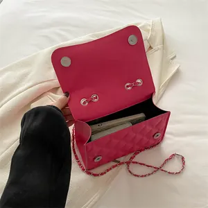 Magenta quilted crossbody bag with silver chain strap and metal magnetic closure