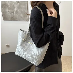 Side view of silver tote bag with marble pattern and metallic detail for commuting