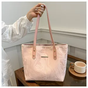 Pink marble pattern tote bag on wooden table with elegant lifestyle setting details