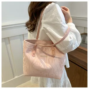 Detail of pink marble pattern tote bag on model showing size and gold metal trim