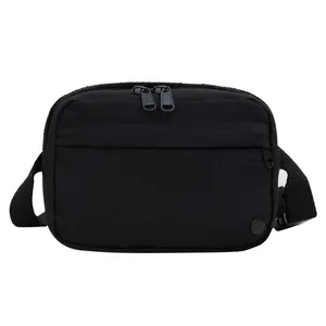 Detail of black multi-zipper shoulder bag with ripstop texture and adjustable strap