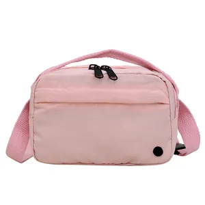 Lightweight pink nylon crossbody bag with dual zippers and front pocket for casual use