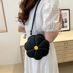 Fashionable black flower shaped crossbody bag with yellow center and adjustable strap