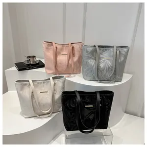 Detail showing wavy marble texture and metal plate on large capacity tote bags set