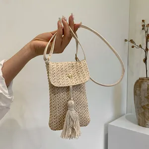 Chic woven straw crossbody phone bag for women with decorative tassel and gold snap button