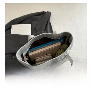 Top view showing large capacity interior of a patterned grey tote bag for daily essentials
