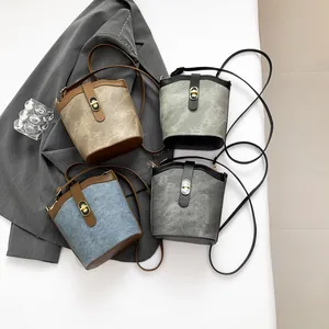 Retro bucket bag with turn-lock closure in multi-color patchwork and leather strap