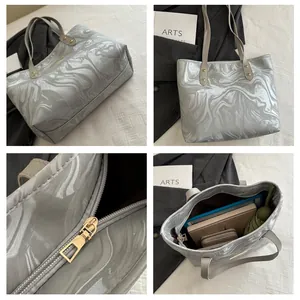 Detail shots of grey marble tote bag featuring gold zipper and large interior capacity