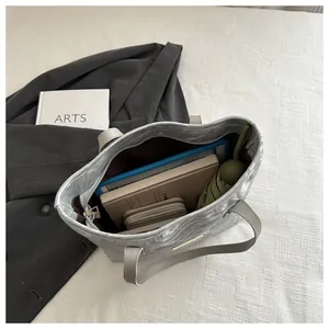 Top view of large capacity tote bag interior showing laptop and daily essentials