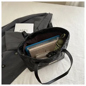 Detail view of large marble print tote bag interior showing spacious capacity and storage
