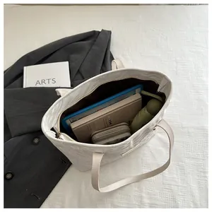 Top view of large capacity white marble tote bag showing spacious interior with daily items