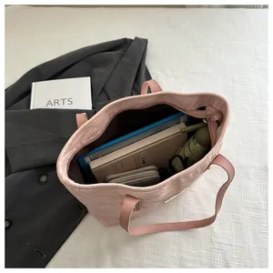 Internal view of pink ripple tote bag showing laptop, notebook, wallet and umbrella