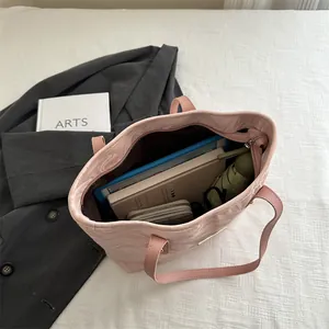 Pink ripple textured tote bag with large capacity holding a tablet and umbrella