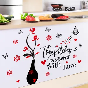 Detail of This Kitchen is Seasoned With Love wall sticker on white cabinet surface