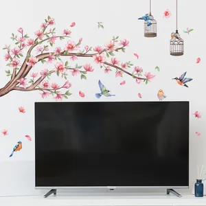 Detalle de vinilos de pared con flores de cerezo, aves coloridas y jaulas estilo acuarela